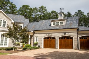 Stained wood triple custom garage doors for large southern home